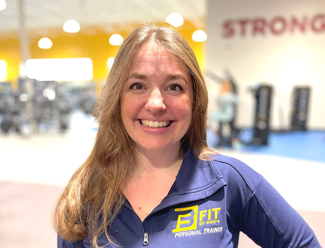 Smiling personal trainer at gym.