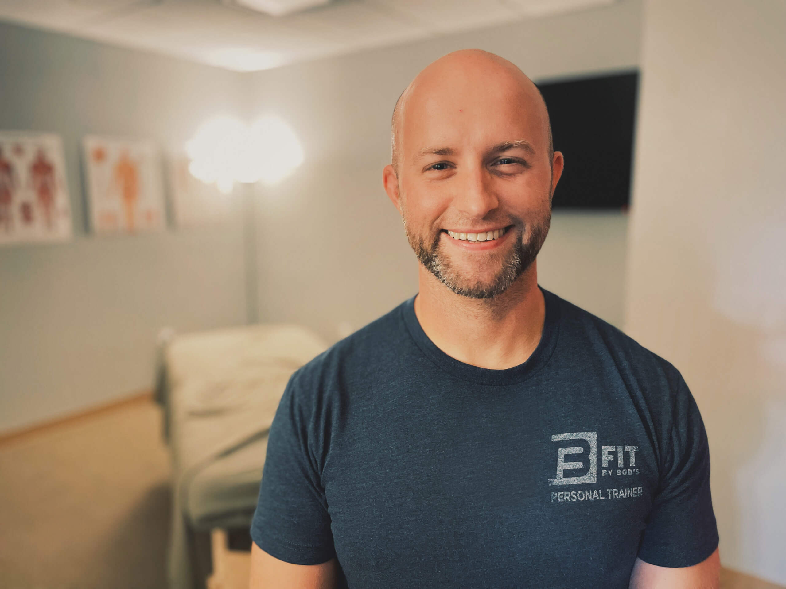 Smiling personal trainer in gym setting
