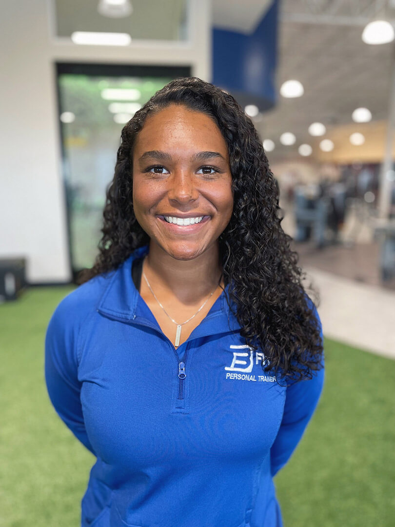 Smiling personal trainer in gym.