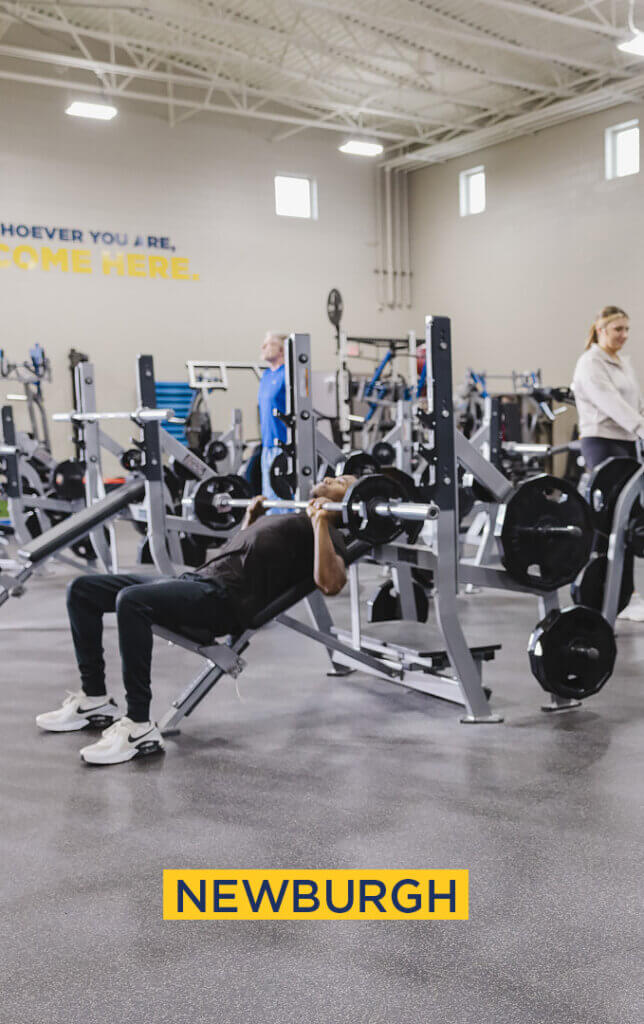 Person bench pressing in Newburgh gym